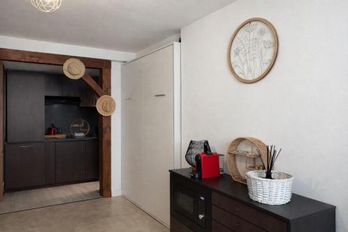 a living room with a clock on the wall at Gîte de Linéa Centre de Loches in Loches