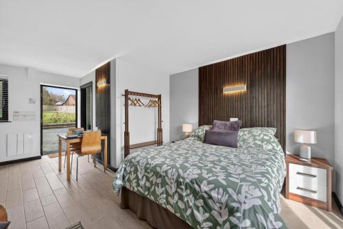 a bedroom with a bed and a table and a desk at 1 Bed in Minsterley oc-s38641 in Minsterley
