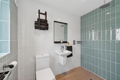 a bathroom with a sink and a toilet and a mirror at 1 Bed in Minsterley oc-s38641 in Minsterley