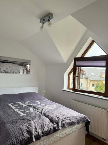 a bedroom with a bed and a window at TOBI-pokoje gościnne in Łeba