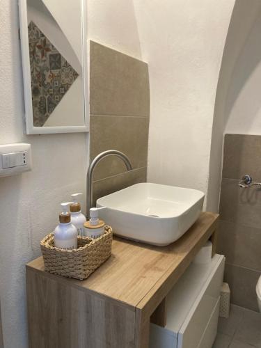 a bathroom with a sink on a wooden counter at F&F Room in Sassari