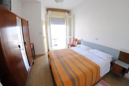 a bedroom with a large bed in a room at Hotel Cristallo Cesenatico in Cesenatico