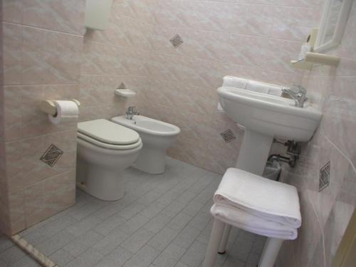 a bathroom with a toilet and a sink at Hotel Cristallo Cesenatico in Cesenatico
