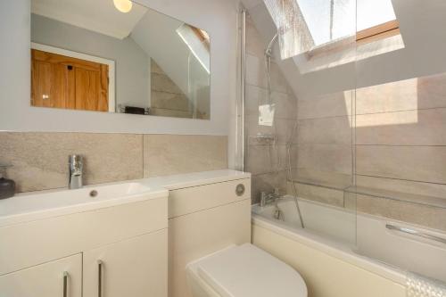 a bathroom with a sink and a toilet and a tub at 2 Bed in Reydon oc-s39034 in Reydon
