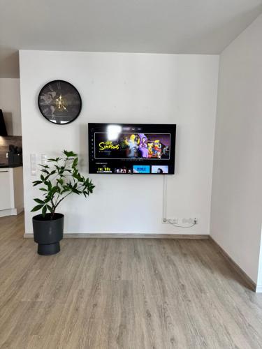 a living room with a flat screen tv on a wall at Feel like Home 8 in Biberach an der Riß