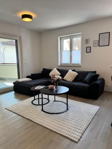 a living room with a black couch and a table at Feel like Home 8 in Biberach an der Riß