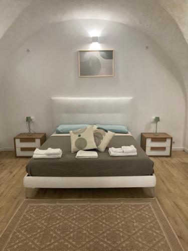 a bedroom with a bed and two night stands at F&F Room in Sassari