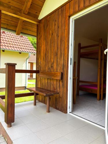 a porch with a bench and a bunk bed at Kemp Koruna in Zlatá Koruna