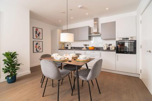 a kitchen with a dining room table and chairs at The Slate Yard in Manchester