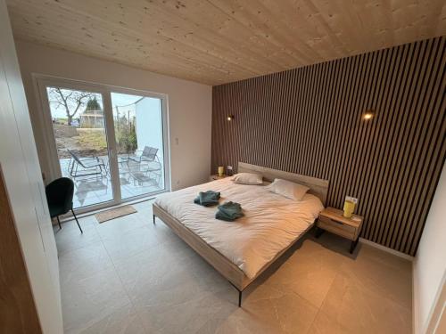 a bedroom with a bed and a large window at NEW - Mullerthal Basecamp - Sleeps 6 in Beaufort