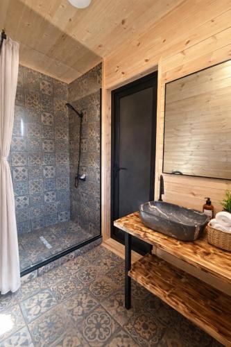 a bathroom with a stone tub and a shower at Mestia Inn Chalet in Mestia