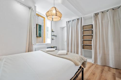 a white bedroom with a large bed and a window at Sky Lodge - Vieux Nice in Nice