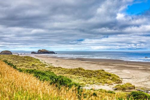 a beach with rocks in the water and grass at Inviting dog-friendly studio with unobstructed ocean views in Bandon