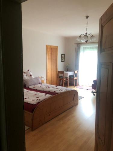 a bedroom with a bed and a dining room at Müllnerbauer in Napplach