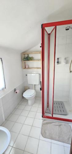 a white bathroom with a toilet and a sink at Villa Rosetta in Airasca