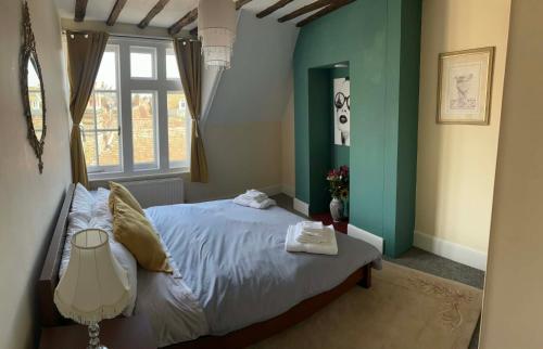 a bedroom with a bed and a window at The Old Bakery in Sandwich