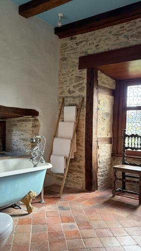a bathroom with a bath tub and a staircase at Chateau Eyparsac in Beyssac