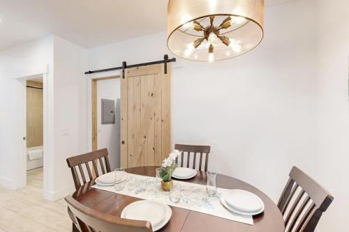 a dining room with a table with chairs and a chandelier at Stunner apt with fireplace grill partial ocean views & partial AC in Gold Beach