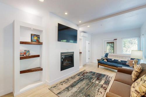a living room with a couch and a fireplace at Stunner apt with fireplace grill partial ocean views & partial AC in Gold Beach