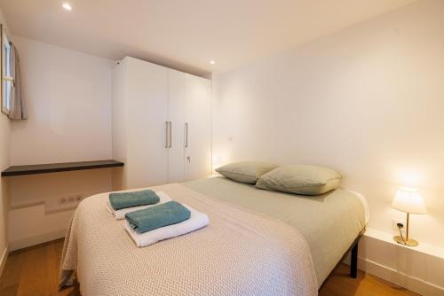 a small bedroom with a bed and a cabinet at Apt Le Frene in Tourrettes-sur-Loup