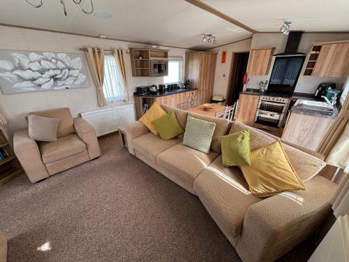 a living room with a couch and two chairs at L60, Two bedroom caravan - California Cliffs, Parkdean Resort, Scratby - Sleeps 6, bed linen, towels plus Wi-Fi included - Sorry no pets in Great Yarmouth