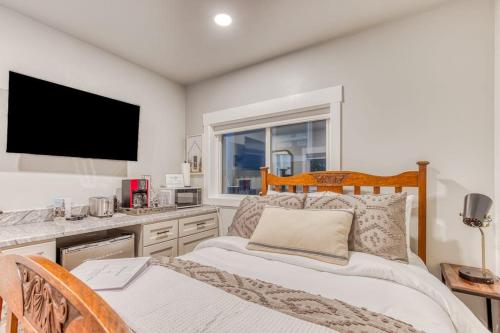 a bedroom with a bed and a television in it at Inviting studio with kitchenette & scenic forest setting in Welches
