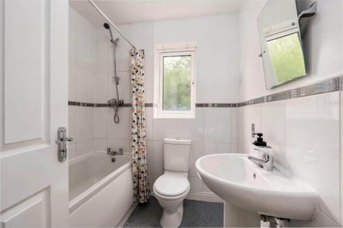 a white bathroom with a toilet and a sink at Hills Close - 3 Bed House - FREE Parking in Mexborough