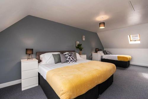 a bedroom with two beds and a blue wall at Hills Close - 3 Bed House - FREE Parking in Mexborough