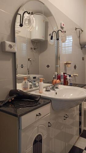 a bathroom with a sink and a mirror at Holiday Calabria Rooms in Lamezia Terme