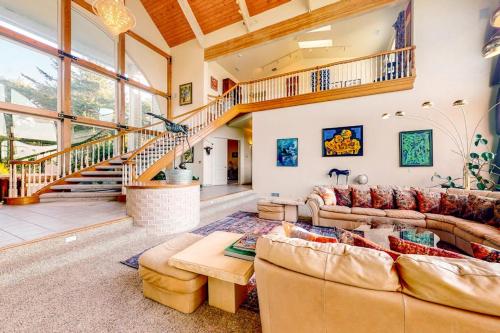 a living room with two couches and a staircase at Stunning Spacious Riverfront House with Private Sauna in Florence
