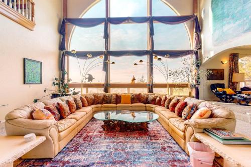 a living room with a couch and a large window at Stunning Spacious Riverfront House with Private Sauna in Florence