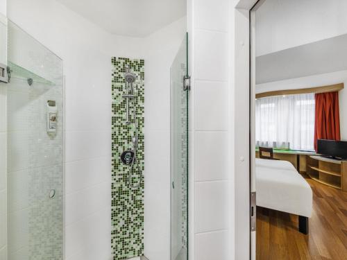 ein Badezimmer mit Dusche mit Glastür in der Unterkunft Ibis Budapest City in Budapest