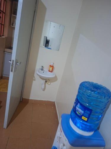a bathroom with a toilet and a sink at Larmar Homes- Kajiado in Kajiado