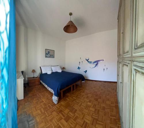 a bedroom with a bed with a blue comforter at Paolo&SilviaHost in Seriate