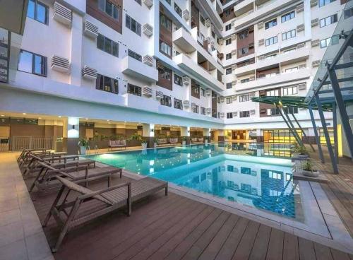 a large swimming pool in the middle of a building at BE Residences Lahug in Cebu City
