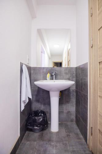 a bathroom with a white sink and a mirror at The Best Hostel in Yerevan
