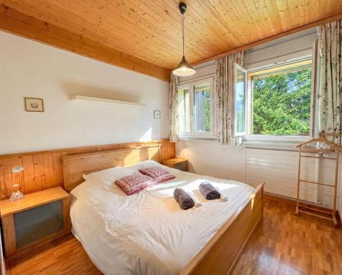 a bedroom with a bed with two towels on it at Villars - Charme et panorama in Ollon