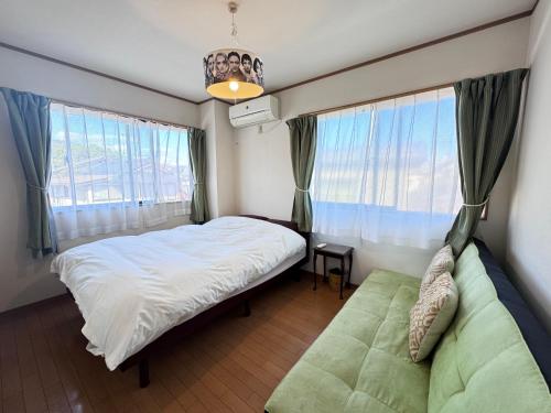a bedroom with a bed and a large window at near to Miyajima in Hatsukaichi