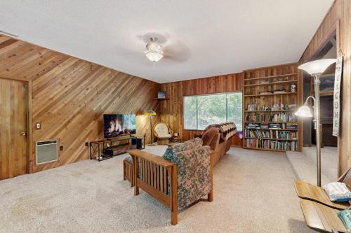 a living room with a couch and a tv at Spacious home with full kitchen wifi private backyard & grill in Welches