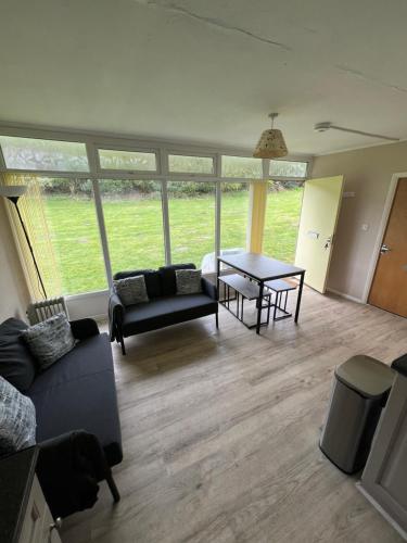 a living room with a couch and a table at Cromer Coastal Retreat Kings Chalet Park in Cromer