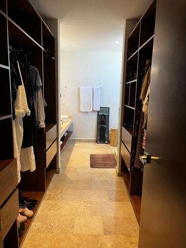 a room with a hallway with a closet and a door at Chicxulub , oceanfront 3 recamaras in Chicxulub