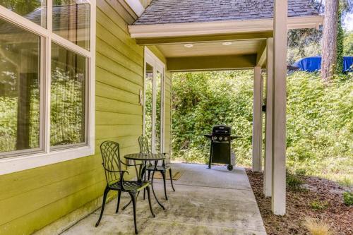 a porch with chairs and a table and a grill at Dog-friendly studio with river view patio grill & shared W&D in Stevenson