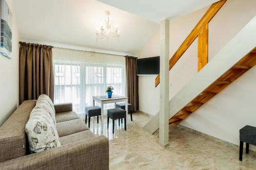 a living room with a couch and a table at Prie Ąžuolo in Juodkrantė