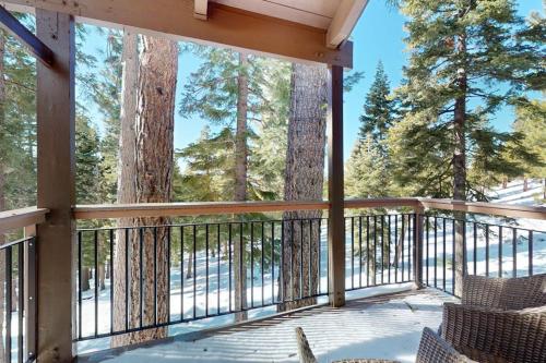 a screened in porch with a view of trees at Cozy condo with mountain views free shuttle & W&D in Ponderosa Fairway Estates