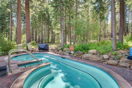 a swimming pool in the middle of a forest at Cozy condo with mountain views free shuttle & W&D in Ponderosa Fairway Estates