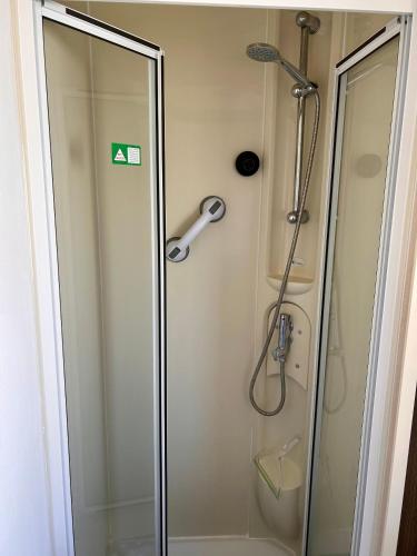 a shower with a glass door in a bathroom at Spacious Holiday Home in Exmouth Ocean Views and Pet Friendly in Exmouth