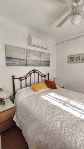 a bedroom with a bed and a ceiling fan at La Casita in Torrox