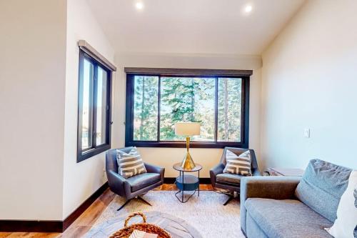 a living room with a couch and two chairs at Ski and Ski Out Designer Condo With a View in Kingswood Estates