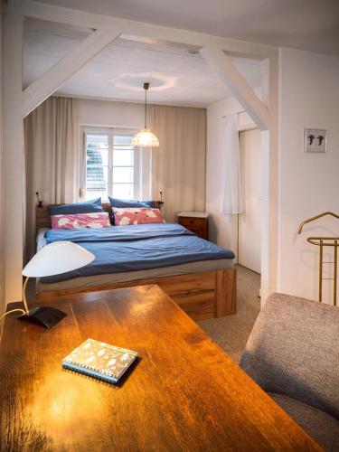 a bedroom with a bed and a coffee table at Frankfurter Haus in Zell an der Mosel