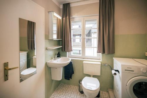 a bathroom with a sink and a toilet and a window at Frankfurter Haus in Zell an der Mosel